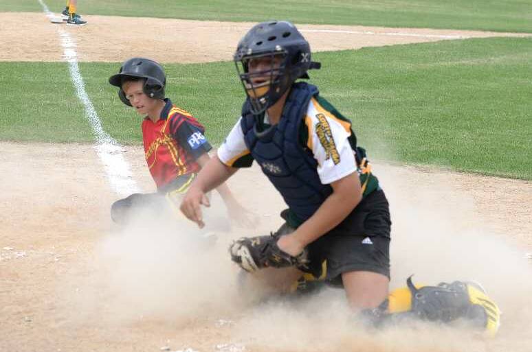 UNDER 14S: George Collins-Kelleher comes in for a slide to home plate with South Wagga Warrior Ryan Ferguson trying to stop him. Picture: Jacinta Coyne