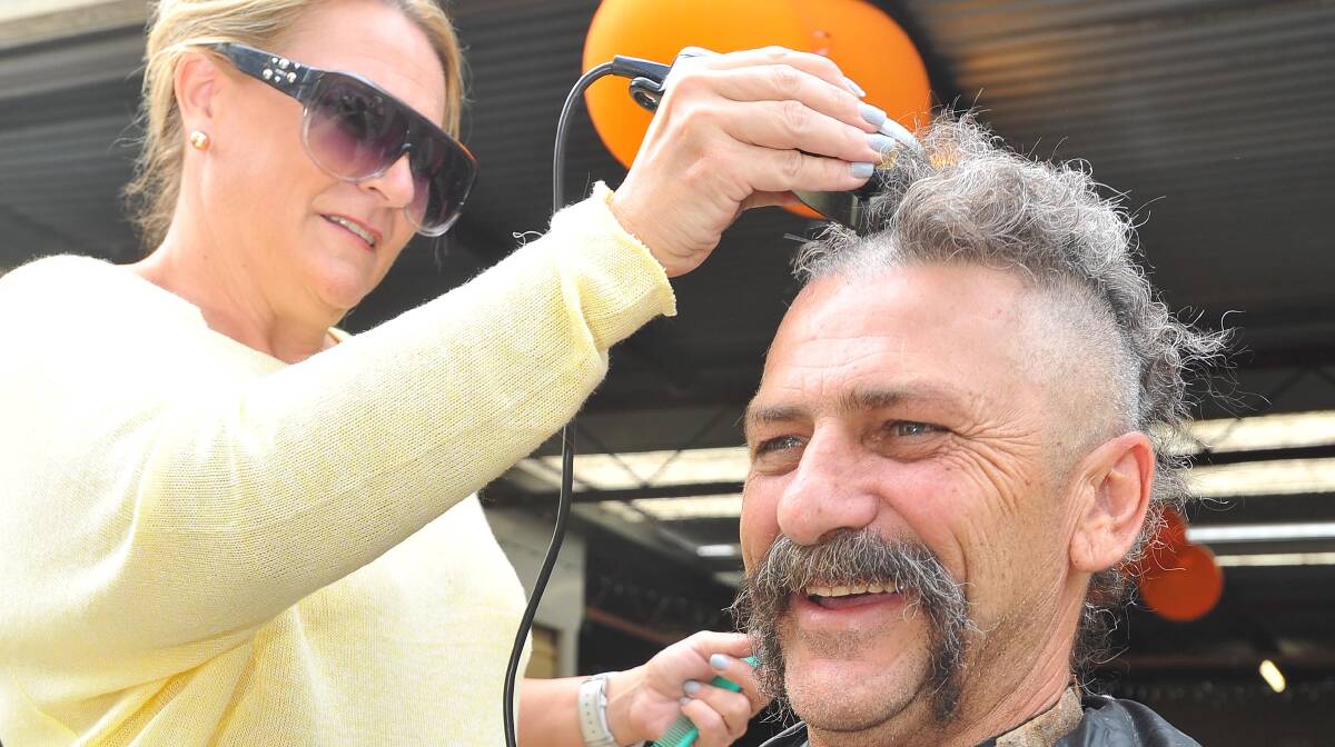 Black Swan Hotel publican Chris Tipping has his head shaved by  Jody Morrow. Picture: Kieren L Tilly