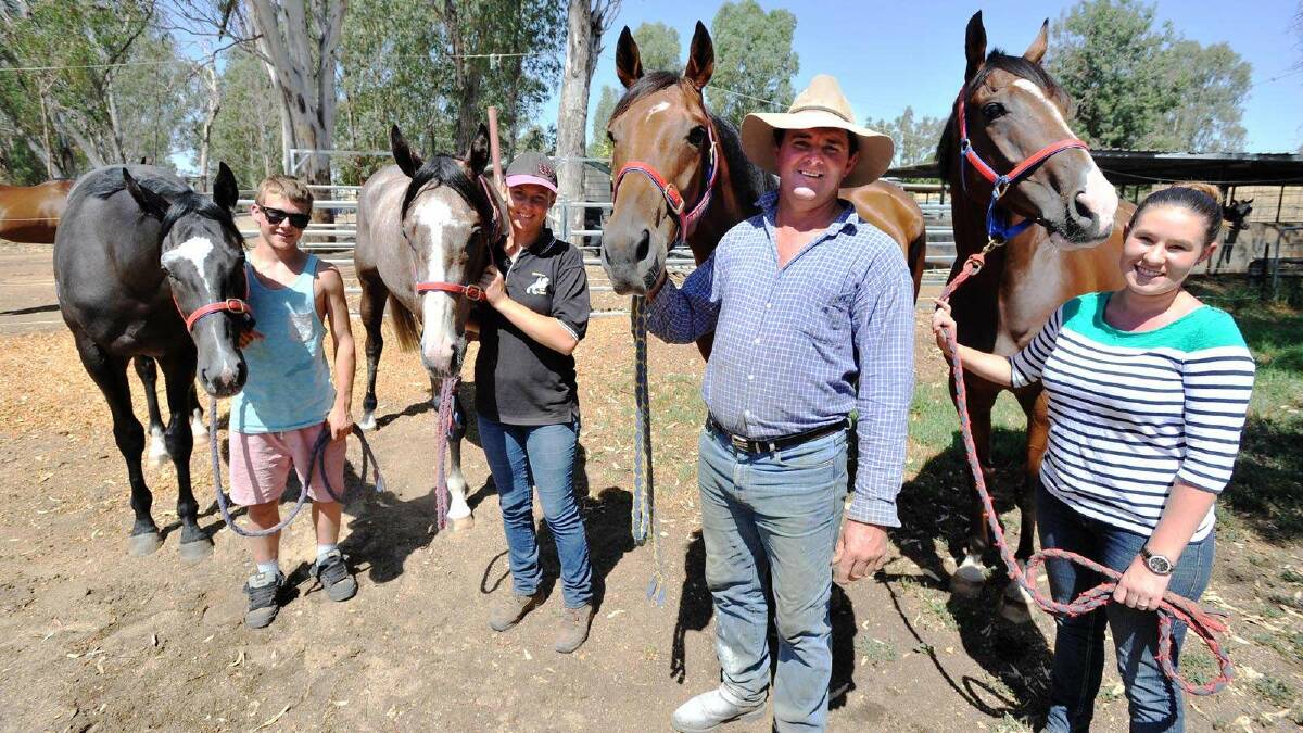 Trainer Trevor Sutherland entered four horses born of the same dam in Wagga races. Pictured are Jamie Gibbons holding 'Lightning Alert', Stephanie Menzies holding 'Power Alert', Trevor Sutherland holding 'King Marvin', and Whitney Ross holding 'Lockmar'. Picture: Alastair Brook