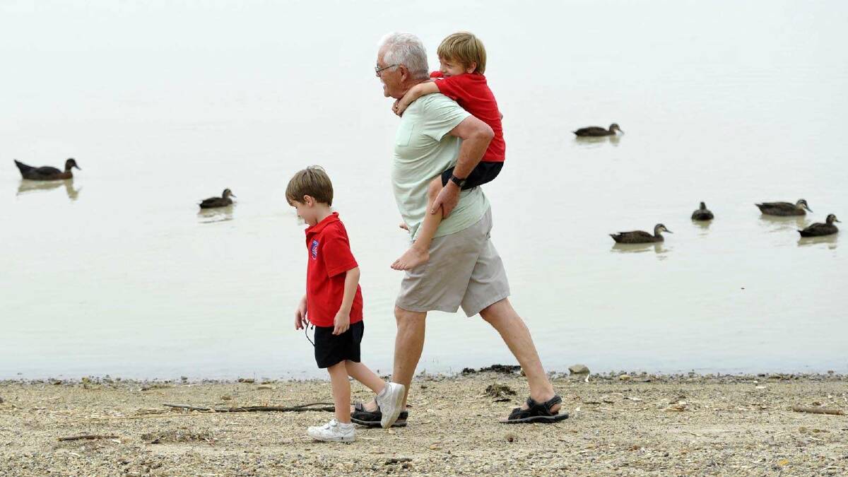 Kevin Brown from Cronulla out for a walk around Lake Albert with twin grandsons Jasper and Anderson Babic. Picture: Les Smith
