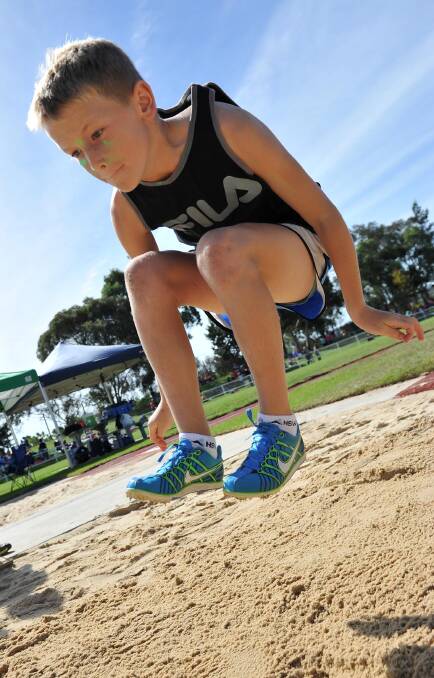 Charlie Wykes, 11, gets some air at the Turvey Park Public School athletics carnival. Picture: Michael Frogley