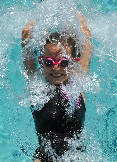 Beth Martini, 9, splashes into the backstroke race at the Kooringal Public School swimming carnival. Picture: Michael Frogley