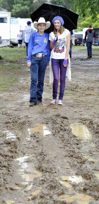 Teighan Worsnop and Rachel Stuckey, both 14, aren't so keen about the mud at the Gundagai show. Picture: Les Smith