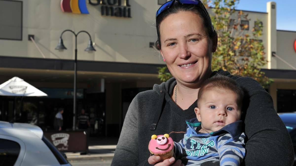 THE GREAT CUPCAKE CAPER: Nat Haigh and Liam Polsen, three-months-old, enjoy a pink cupcake on Baylis Street. Picture: Micahel Frogley