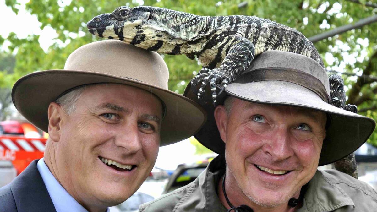 Riverina MP and Michael McCormack and Anthony Stimson from the South Coast get up close and personal with a goanna at the Gundagai show. Picture: Les Smith