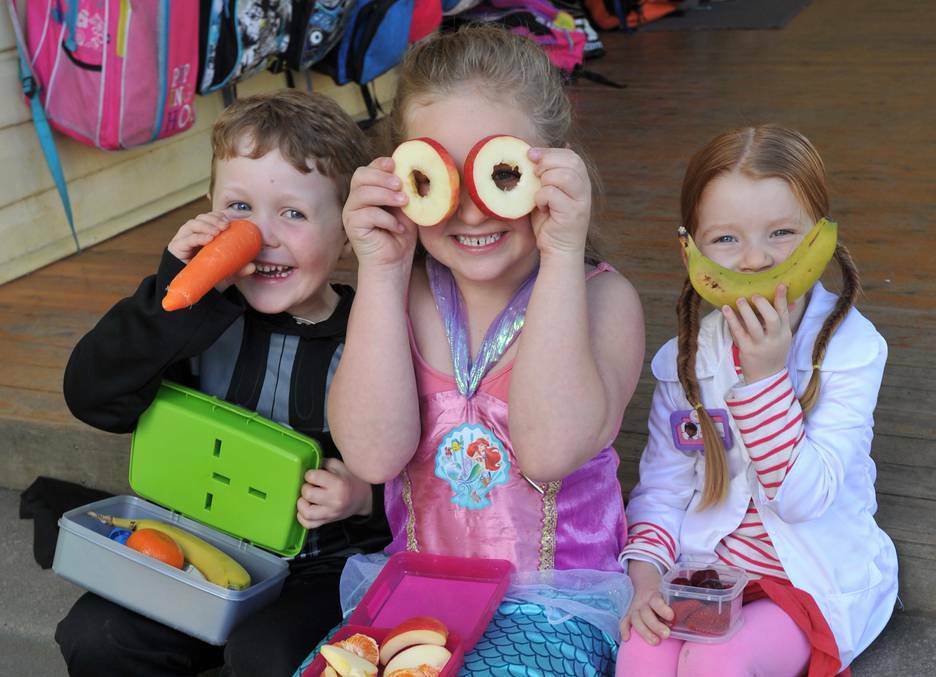 Wagga Public School students Sydney Whyte, 5, Emma Livingstone, 6, and Chelsea Martin, 5, encourage healthy lunch boxes. Picture: Michael Frogley