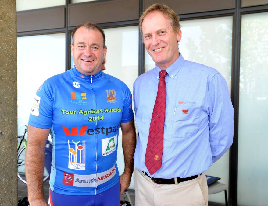Chris Davey, one of the riders on the CASE tour from Hay to Canberra, and Rob Balding from Westpac catch up at the welcome barbecue yesterday. Picture: Laura Hardwick