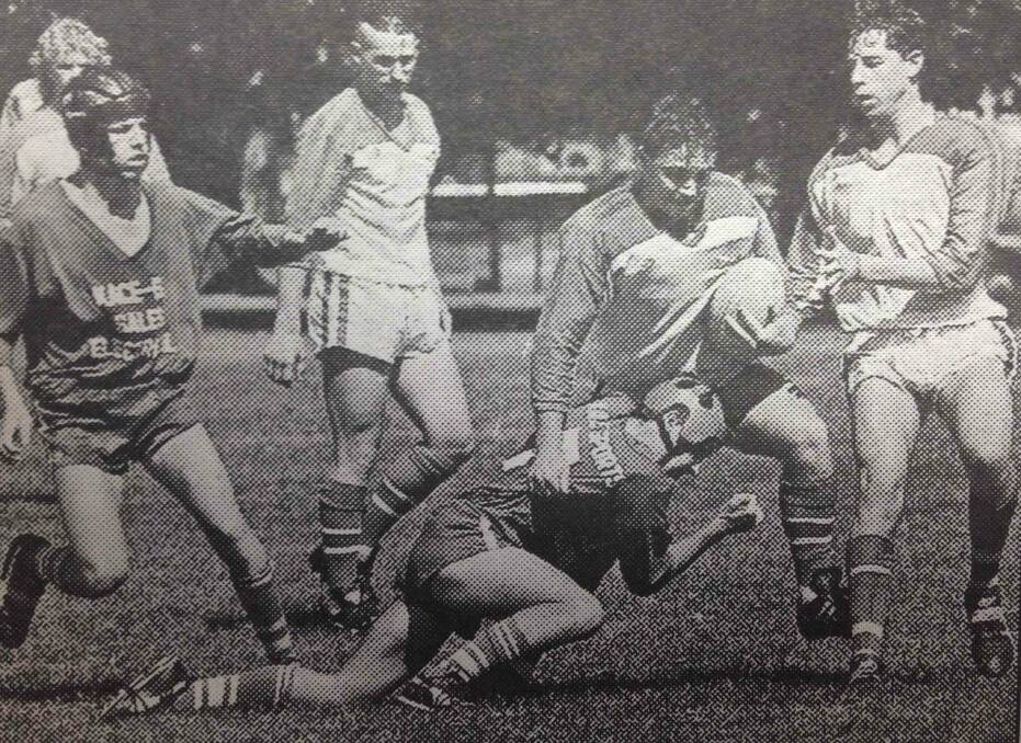 Young High School hooker Damien Ricketts struggles to break away from a tackle by Cootamundra halfback Jamie McDonald during the Commonwealth Bank Cup. Young fullback Max Hoffman and second-rower Jamie Bruce are in support of the ball-carrier. Young High won 16-14.