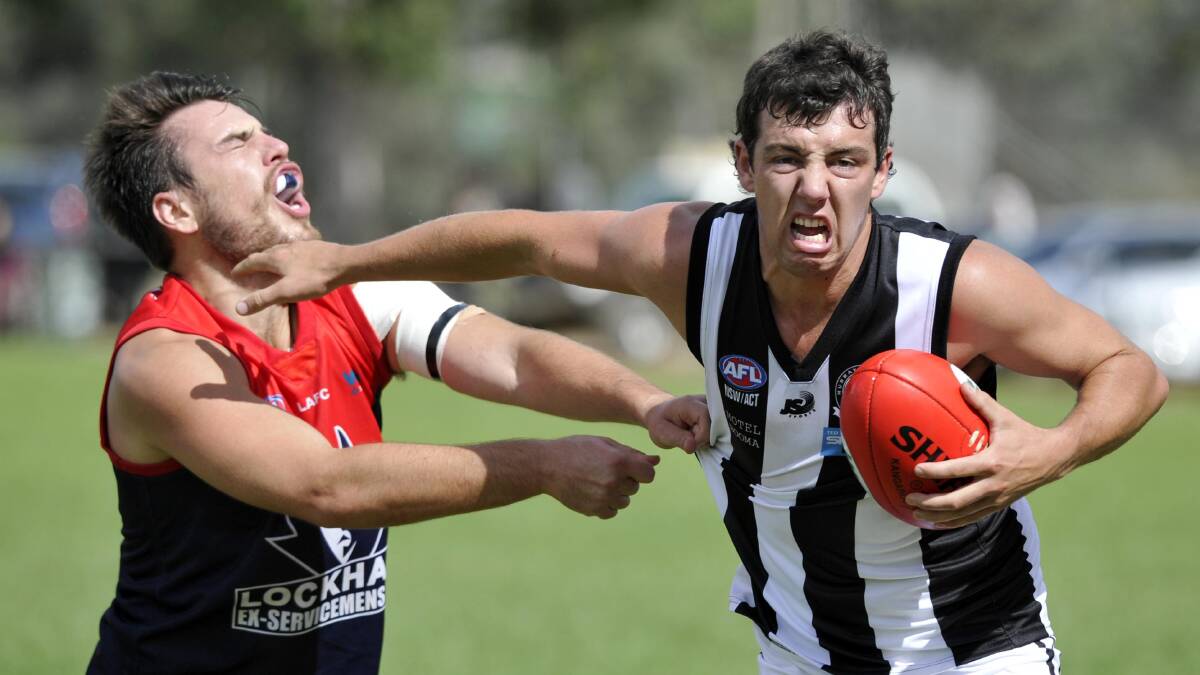 Lockhart's Bryce Koop grabs for Murray Magpies' Daniel Mannagh in the opening game of the 2014 Hume League season. Picture: Les Smith