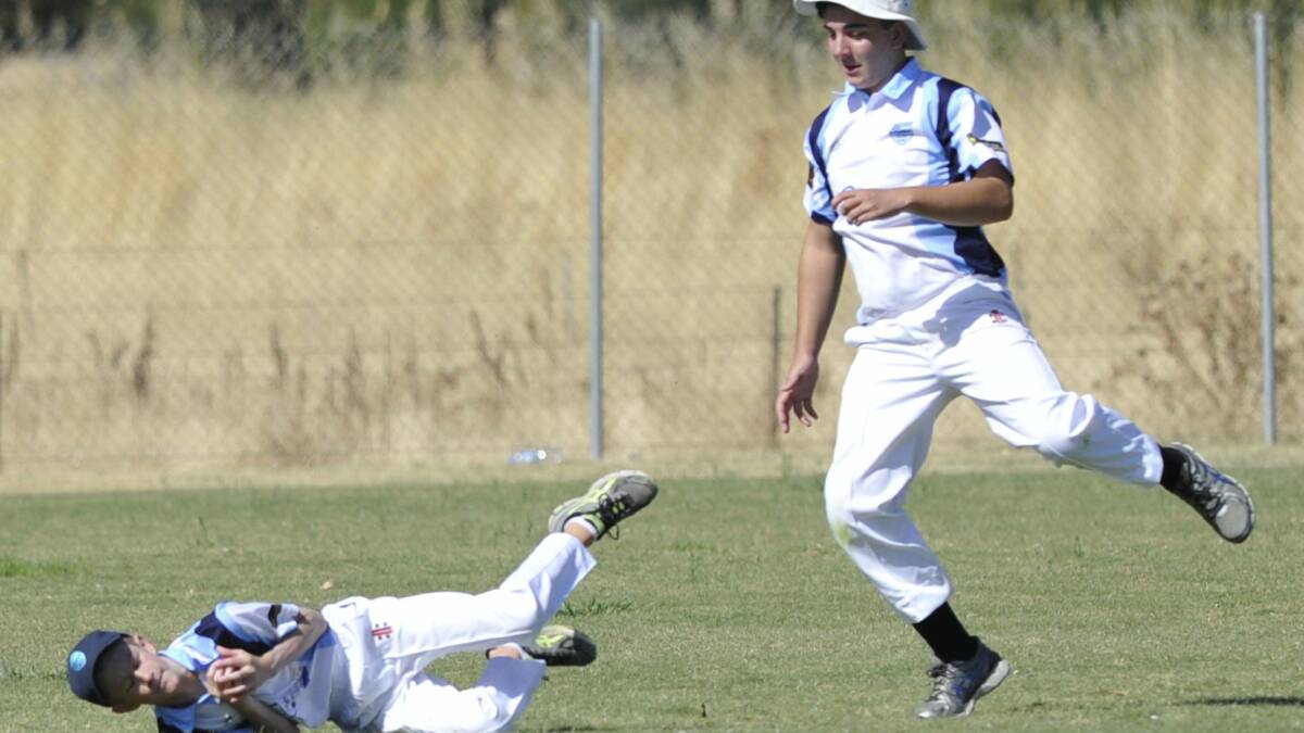 Coen Brand puts his body on the line to dismiss a Lake Albert batsman in the 15 years cricket. His South Wagga teammate, Tom Heffer, was there for support. Picture: Les Smith