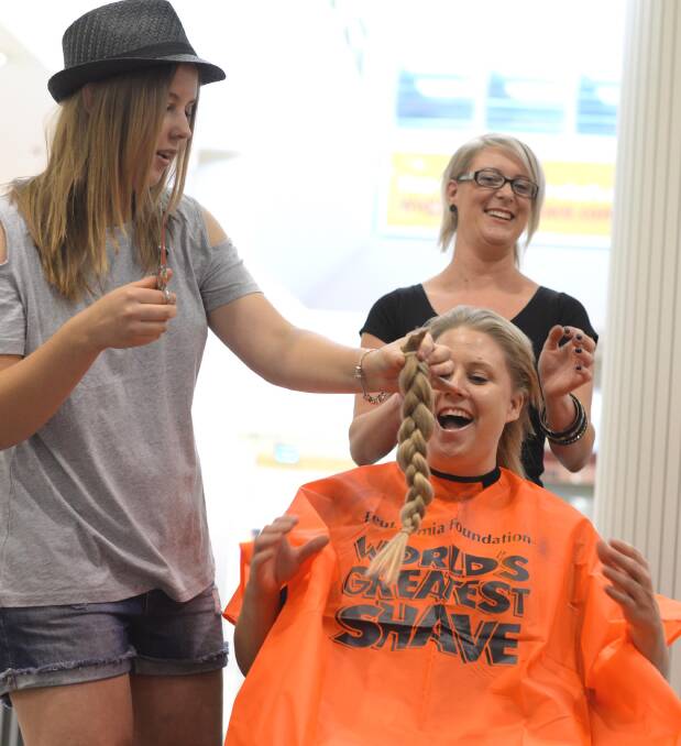 Kellie Roberts shaved for a cure, with daughter Maddie cuttong off the first of her mother's hair. Picture: Jacinta Coyne