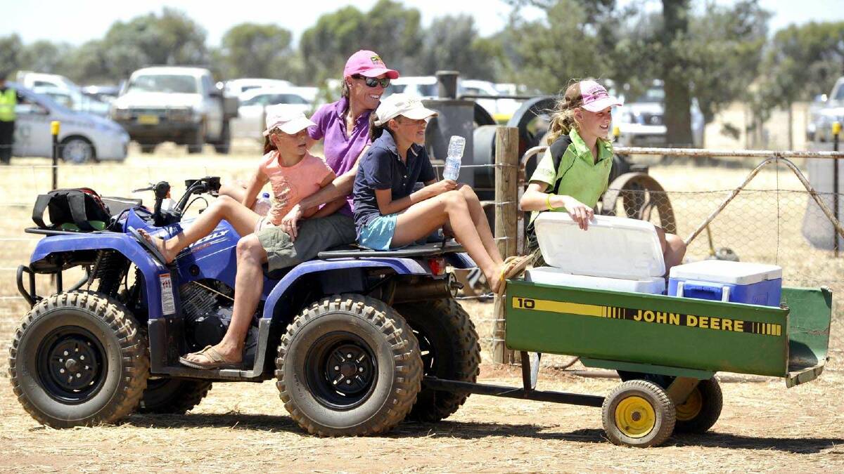 The Scholz girls - Chloe, 8, Alana, 12, and Brittany, 14, with mum Annie - hand out drinks to parched patrons at the vintage harvest day at Pleasant Hills. Picture: Les Smith