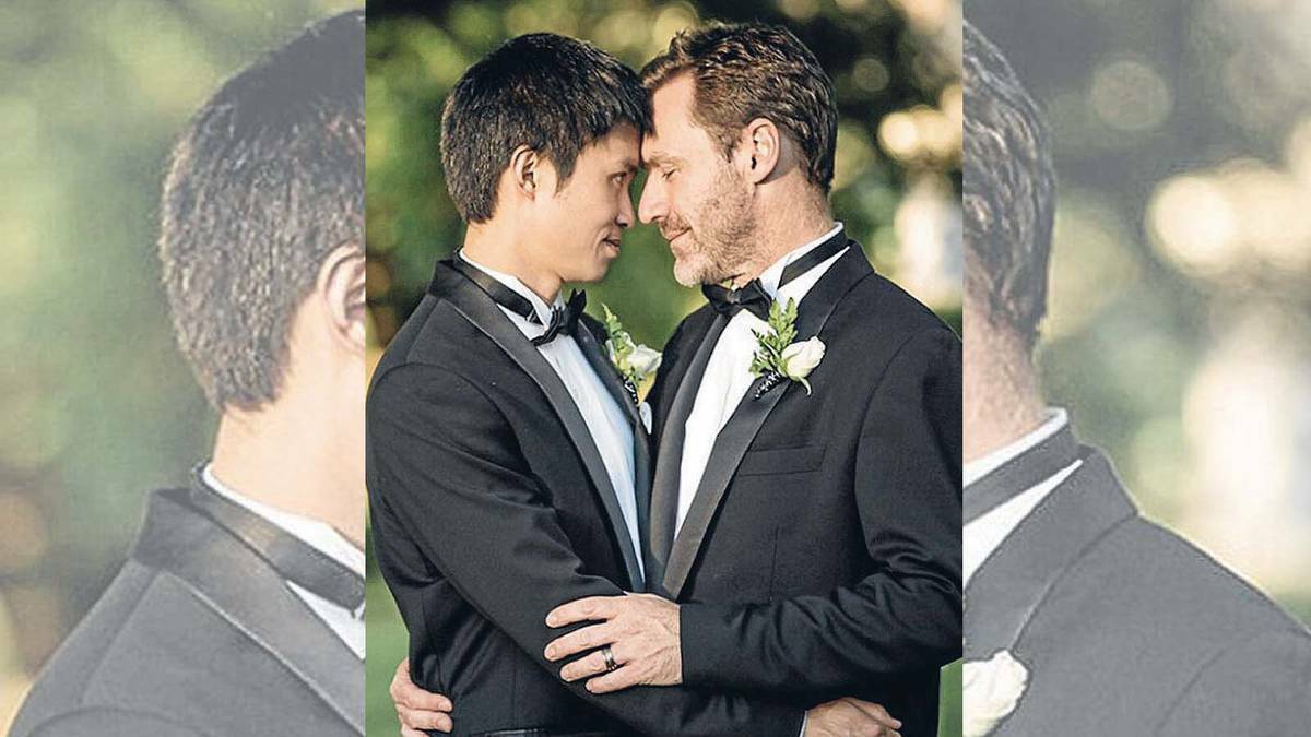 Same-sex couple Chris Teoh (left) and Ivan Hinton, hug after taking advantage of the ACT’s same-sex marriage laws. Picture: Same Love Photography