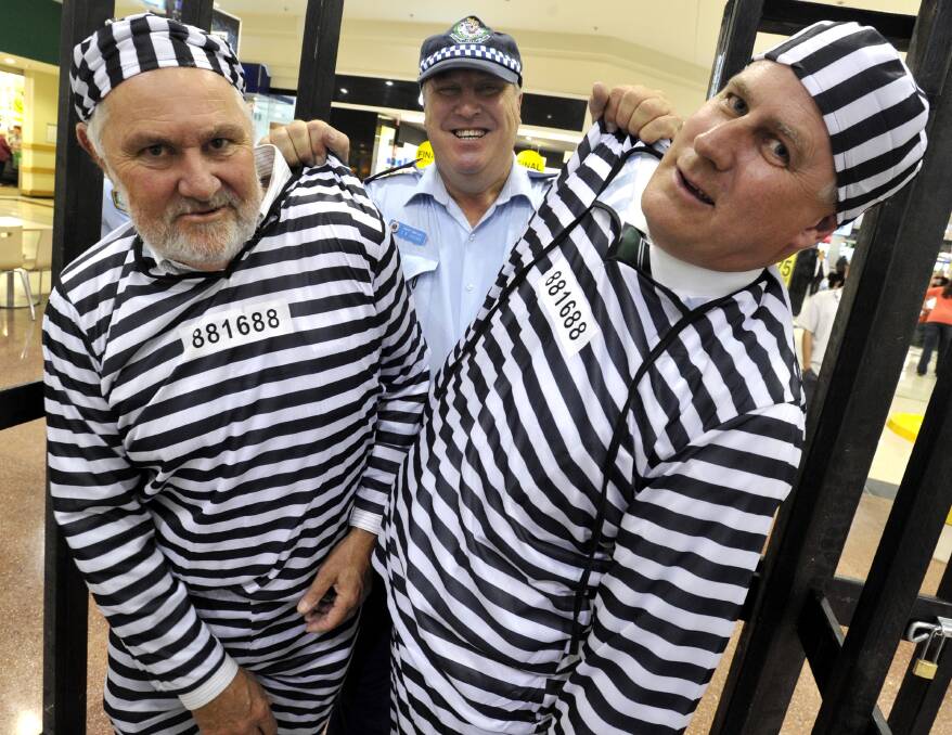 Member for Riverina Michael McCormack and mayor Rod Kendall did time behind bars on Thursday to raise money for the PCYC. Picture: Les Smith