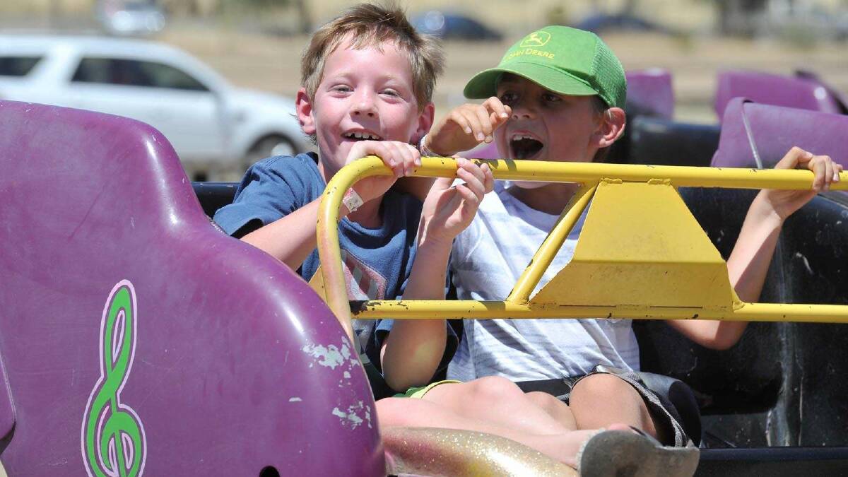 Harry Doig and Jonathon Cooe, both 7, have a ripper of a time on the cha cha at the Henty show. Picture: Alastair Brook