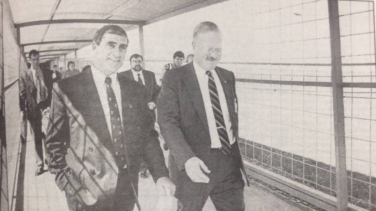 NSW Premier John Fahey and Governor of the Junee Correctional Centre George Grigas stroll along one of the covered walkways which link the cell blocks after the official opening ceremony.