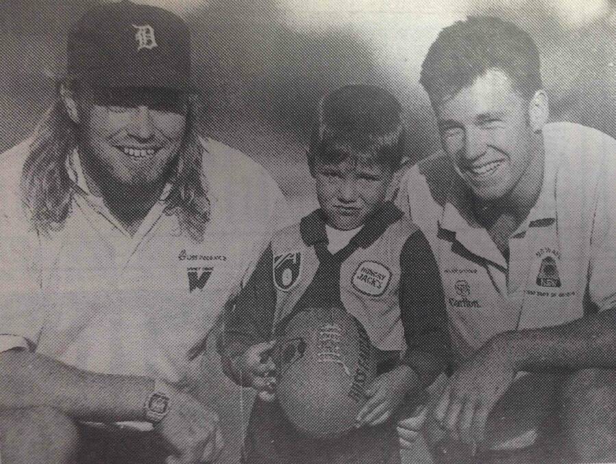 Christopher Agnew, 5, was given some individual pointers by Sydney Swans stars Paul Atkins and Troy Gray during a coaching clinic.