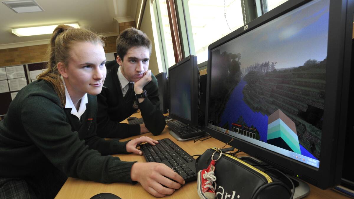 TRAC students Charlotte Moseley and Richard Boxsell, both 16, are hooked on Minecraft. The virutual world is being used as part of the school's immersive approach to learning. Picture: Les Smith