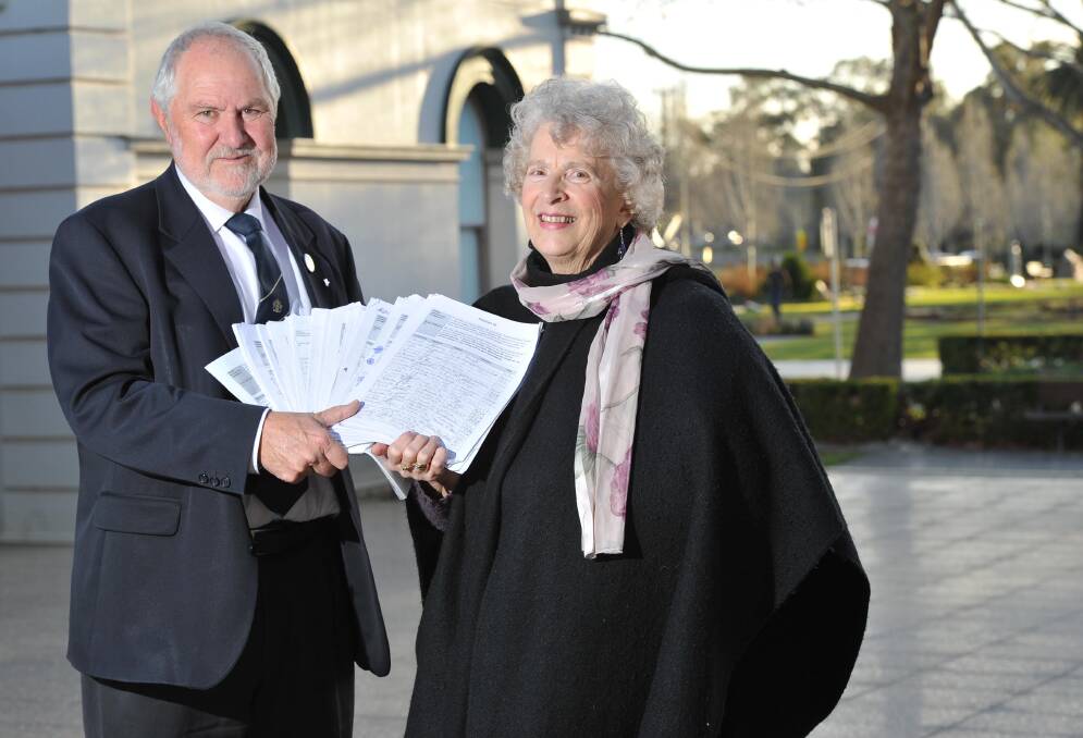 Ronda Lampe - the public face behind a community push to have the Wagga Visitor Information Centre return to Tarcutta Street  - presents the final batch of petition signatures to mayor Rod Kendall before Monday night's meeting. Picture: Laura Hardwick