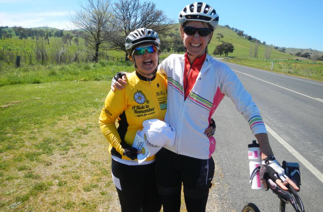 Libby Day (left) is cycling from Melbourne to Canberra as part of "A Ride to Remember", which raises money and awareness for Alzheimer's research and honours her late mum, Molly. Libby visited Wagga on Thursday and made the trek to Gundagai yesterday, where she met another cyclist, Vanessa, on the road. Picture: Contributed