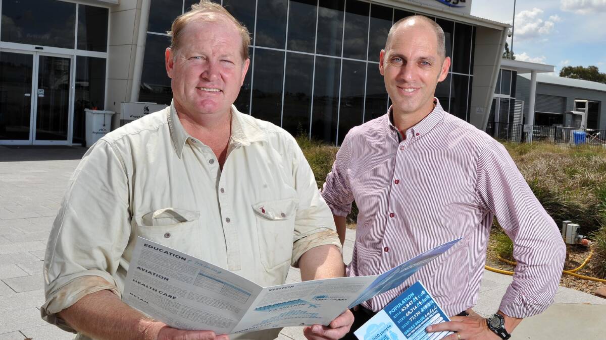 BRIGHT PROSPECTS: Wagga deputy mayor Andrew Negline and director of commercial and economic development Peter
Adams examine the city’s latest economic snapshot. Picture: Michael Frogley
