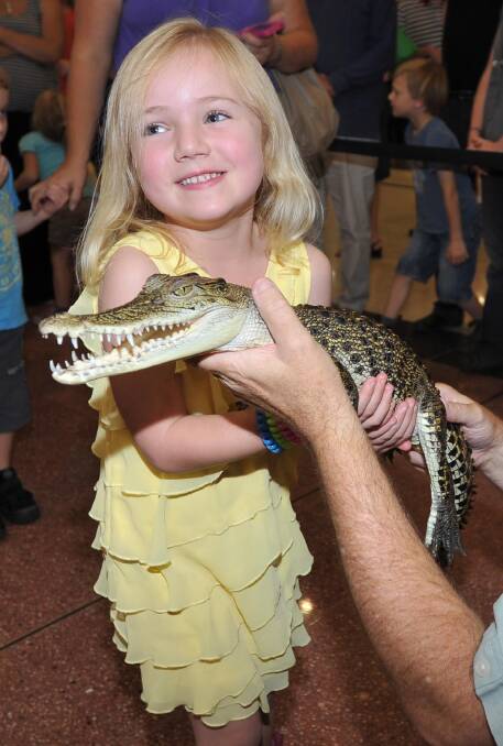 Miah Robertson, 5, lets everyone know that she can show her teeth too during the Crocodile Encounters school holiday reptile show at the Wagga Marketplace this week. Picture: Laura Hardwick