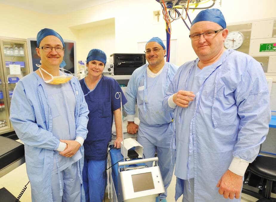 Wagga urologist Dr Ray Stanton (second from right) denies the pressing need for a specialist prostate cancer nurse given the town's excellent resources. He is pictured at work at Calvary Hospital with  surgical assistant Dr Mark Smith (left), operating theatre nurse Jean Hille and urologist Dr Rob Thomas. Picture: Kieren L Tilly