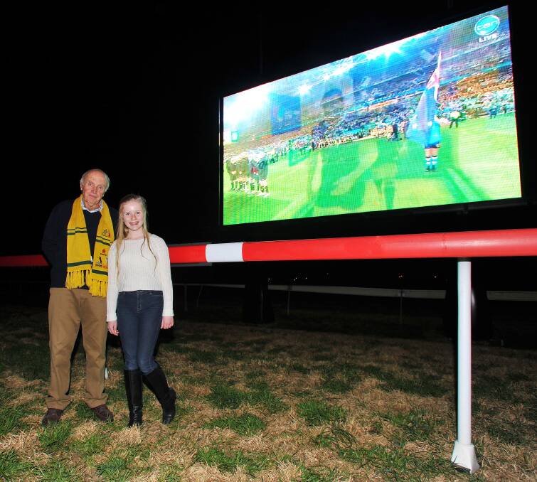 Riverina Bluebell committee member John Bull and Caroline Smith, 10 in front of the big screen at the MTC as the Bledisloe Cup begins in Sydney.  Picture: Kieren L Tilly