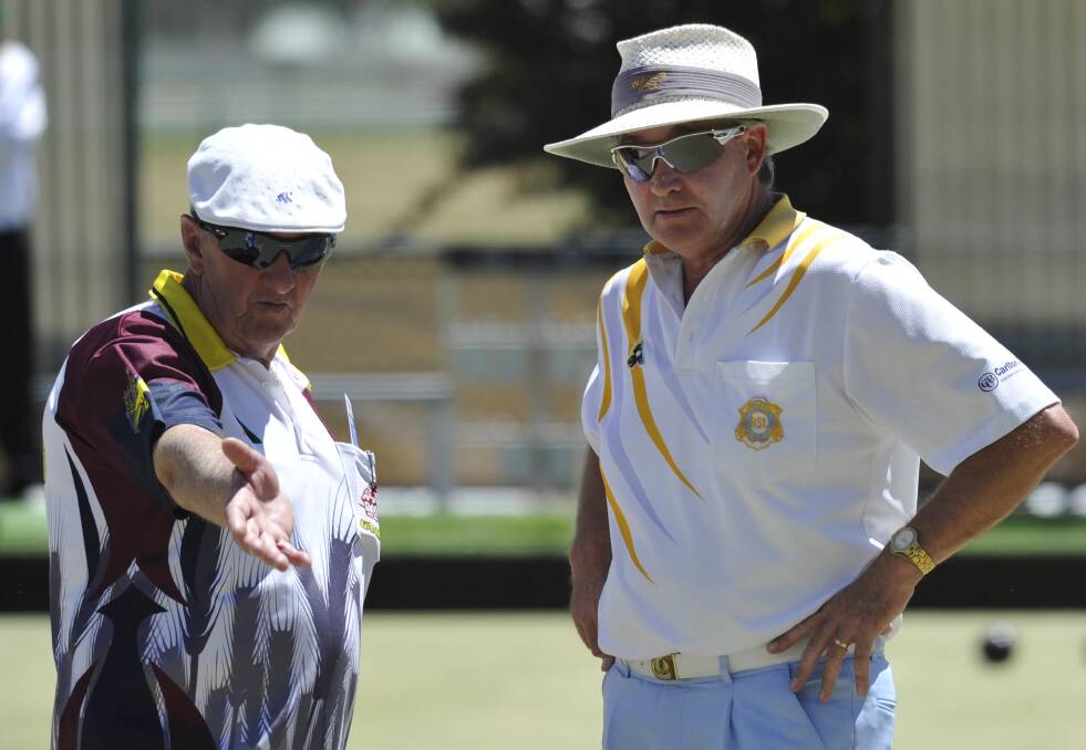 TALKING TACTICS: Ganmain's Chris Cooney and Wagga RSL's David Inglis discuss options during play at the three bowls pairs event.