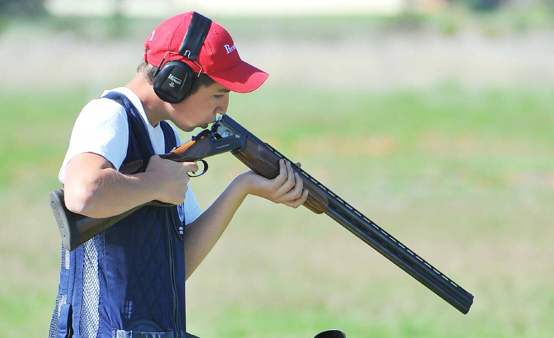 YOUNG GUN: Successful junior Mitchell Iles cleans out his barrel during the final day of the National Trap Championships at the National Shooting Ground on Sunday. Pictures: Kieren L Tilly