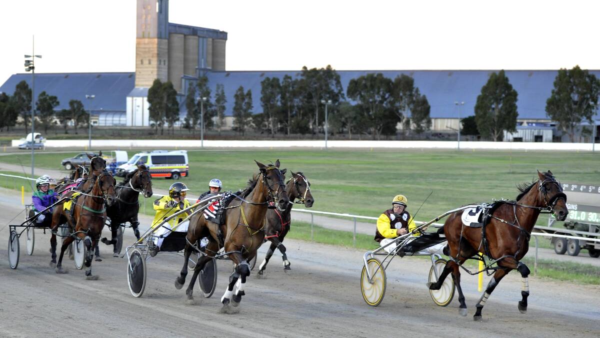 FIGHT TO THE FINISH: Hollywood Sign with Trevor White holds off Bruce Harpley and Sokys Bigbullet to win the Junee Pacers Cup last night. Pictures: Les Smith