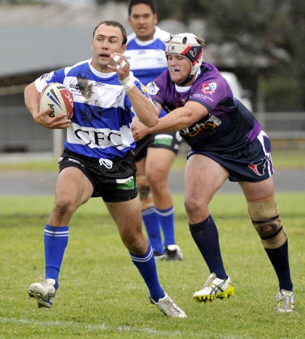 STAYING PUT: Southcity lock Mitch Curran (right), pictured tackling Cootamundra's Grant Boyd, has rejected offers from Temora to stay with the Bulls.