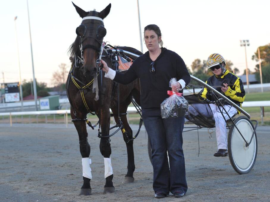 Kim Hillier holds Acey Ducey after winning a race at Leeton in 2012.