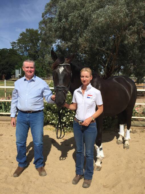 SWEET SUCCESS: John and Sharon Potter celebrate their national honours with Bradgate Park Delilah at their Wagga property yesterday. The husband and wife combination won gold medals with the six-year-old mare and Silbermond, who also took out the national championship last weekend.