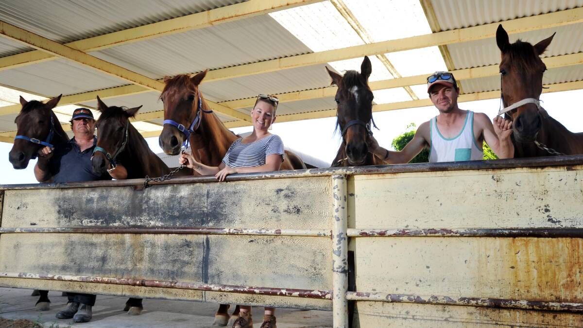 MORE THAN A HANDFUL: Paul Diessel, Georgia Marks and Matt Harington help prepare Kahlefeldt's five runners, Redbank Under Fire, Redbank Inferno, Lettuceplayginger, Redbank Harry and Lettuceventilate, for the three-year-old race at Wagga today. Picture: Laura Hardwick
