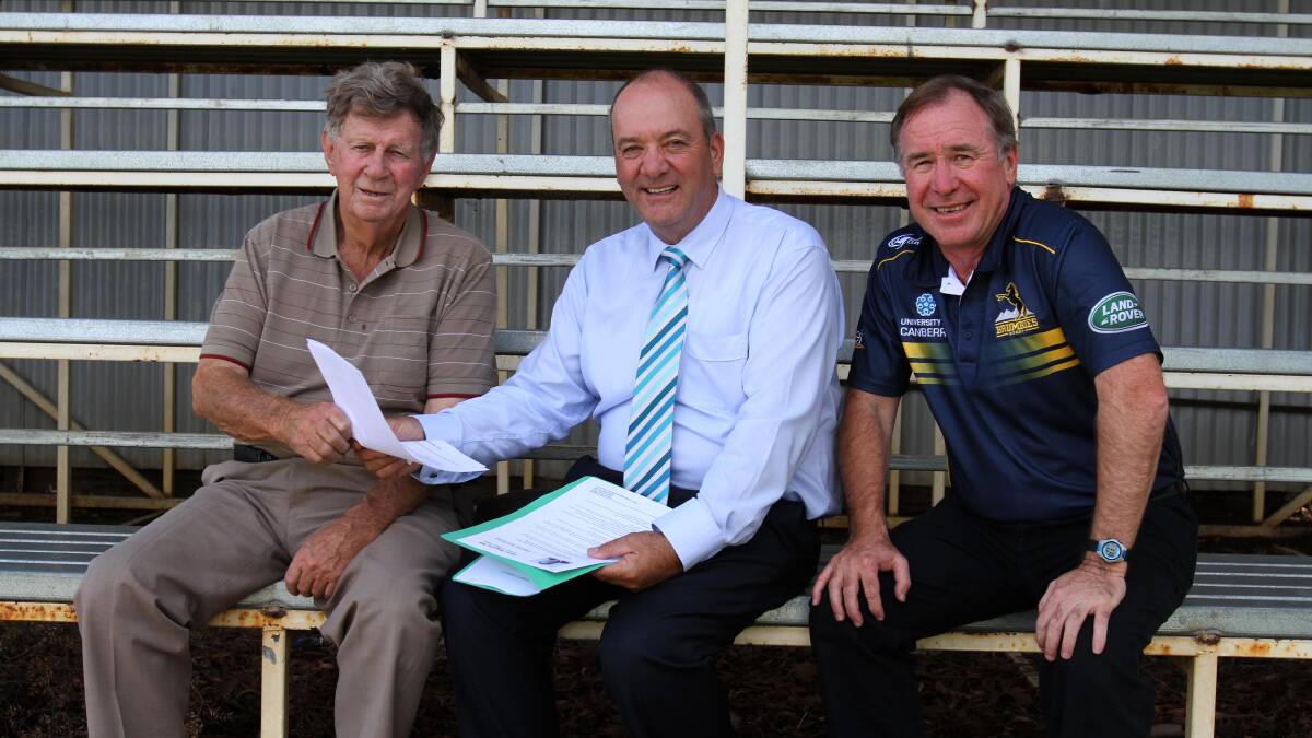 KICKING NEW GOALS: Rugby stalwart Bob Conelly (left) and Southern Inland Rugby Manager Mick McTaggart (right) go through the details on a new $25,000 state government grant with Member for Wagga Daryl Maguire. Picture: Courtney Rees