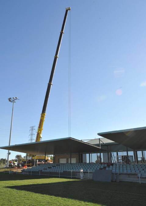 READY TO GO: A giant crane towers over the Equex Centre grandstand waiting for council approval to remove the roof. Preparations started yesterday for the $300,000 project to ready to ground for the City-Country game. Picture: Laura Hardwick