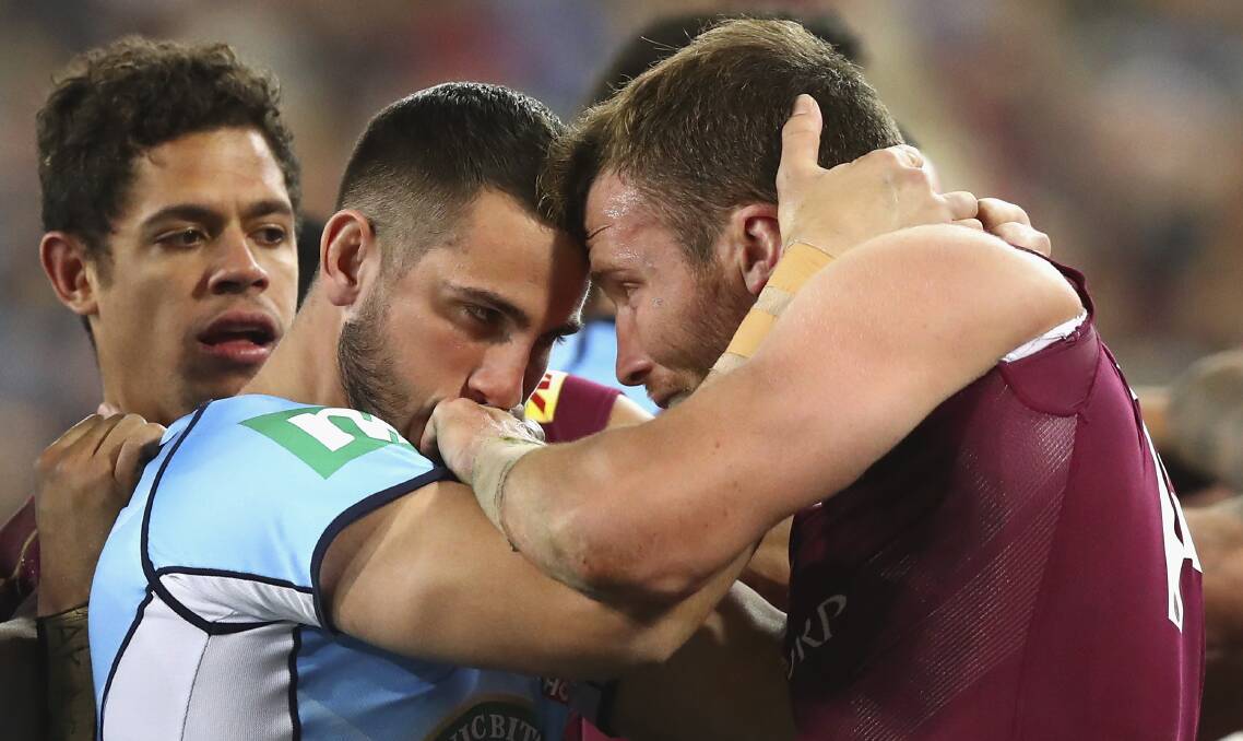 Game on: Jack Bird of the Blues and Gavin Cooper of the Maroons clash during the 2016 State Of Origin series between NSW and Queensland. Photo: Getty Images