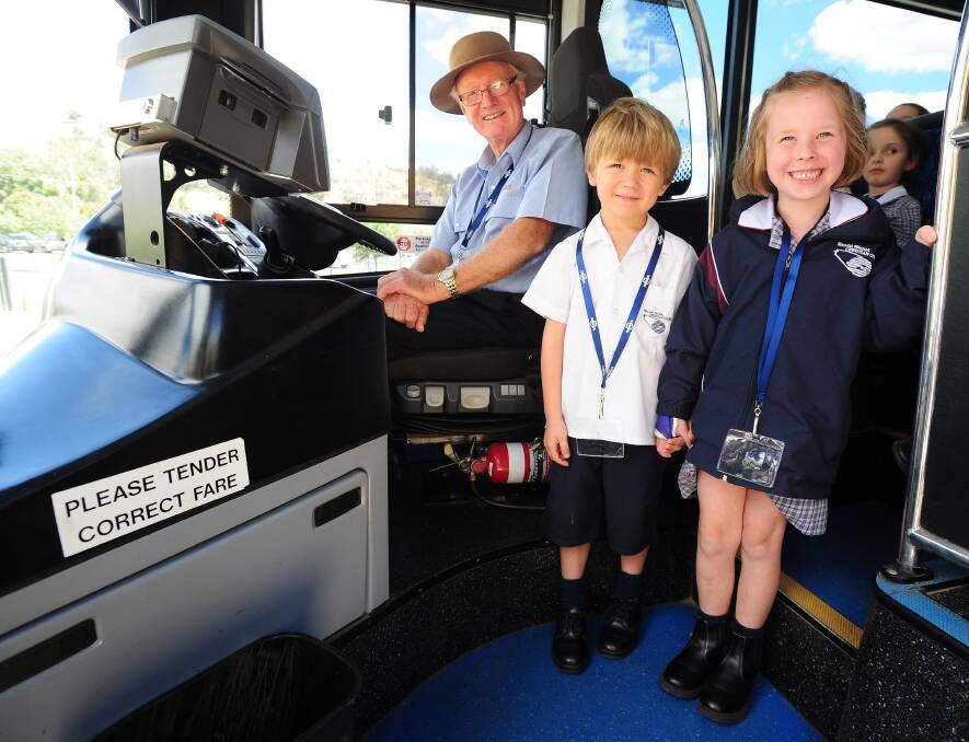 ALL ABOARD: Driver Neil McMullen with Hamish Brown and bus buddy Adelaide Deighton learning proper bus etiquette. Picture: Kieren L Tilly.