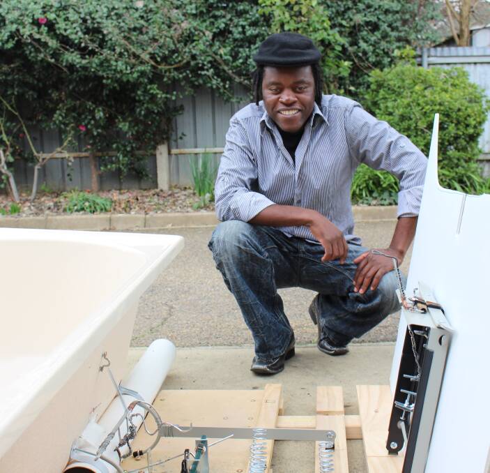INNOVATOR: Rod Mafohla shows the internal springs and levers that control an emergency flap in the home bath tub. Any adult who weighs more than 40 kilograms will not trigger the contraption. Picture: Jack Morphet