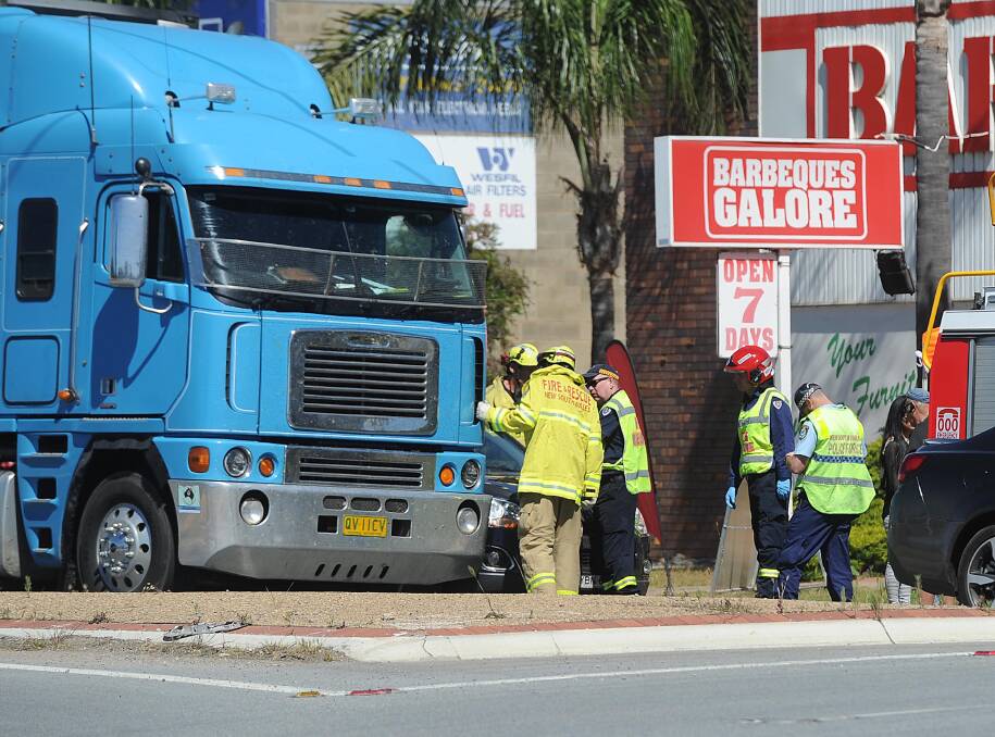 SIDESWIPED: Emergency services attend a crash between a B-double and a Holden SUV at 2pm on Thursday, forcing traffic to wait. Picture: Laura Hardwick