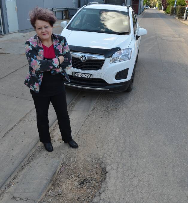 FULL OF HOLES: Junee resident Judy Henderson claims driving in the region has become incredibly dangerous on account of potholes in local roads.
