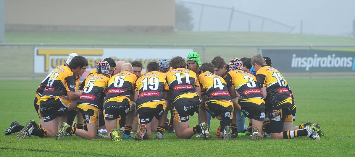 Gundagai Tigers under 16 side take a knee in memory of late teammate Lui Polimeni at Equex Centre on Sunday. Picture: Kieren L. Tilly