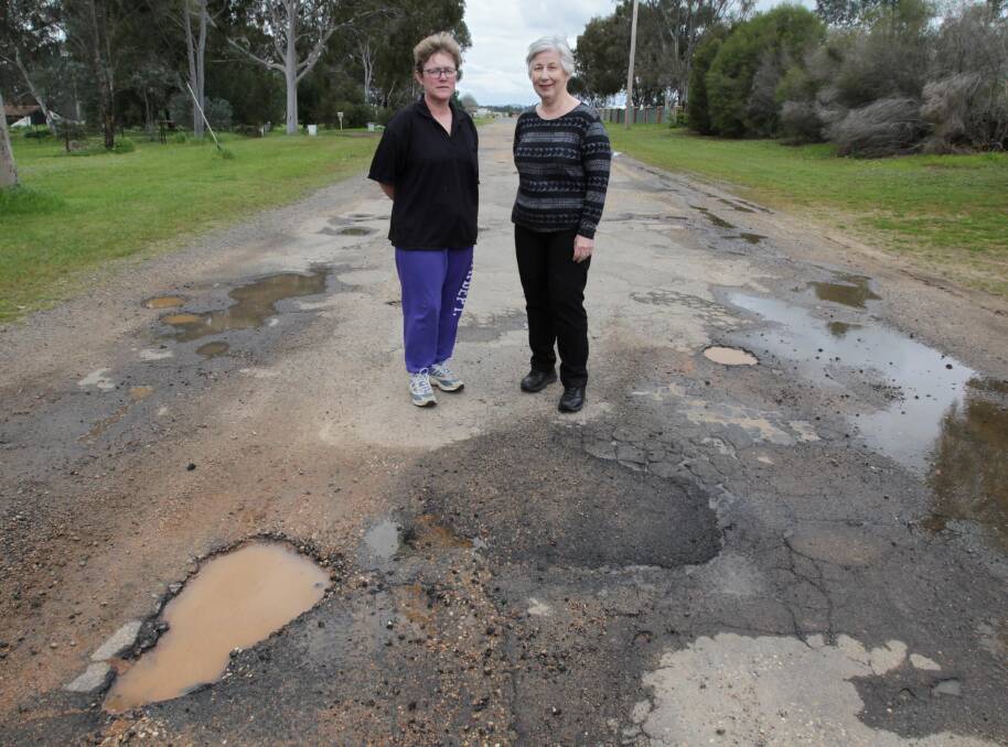CRUMBLING APART: Laurel Road residents Kim Green and Dorothy Grady claim council's efforts to patch potholes were making matters worse. Picture: Les Smith