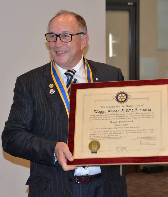 TOP JOB: New Rotary Club of Wagga president Paul Galloway accepts the club charter, which went missing for 44 years between 1961 and 1995, at the Wagga Country Club on Thursday night. Picture: John Egan