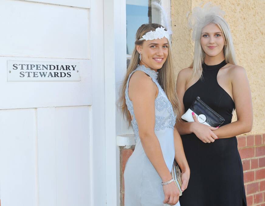 SURVIVAL GUIDE: Kelly O"Reilly and Sophie Preston at the Wagga Town Plate last year have excelled at the art of autumn racing fashion. Photo: Kieren L. Tilly. 
