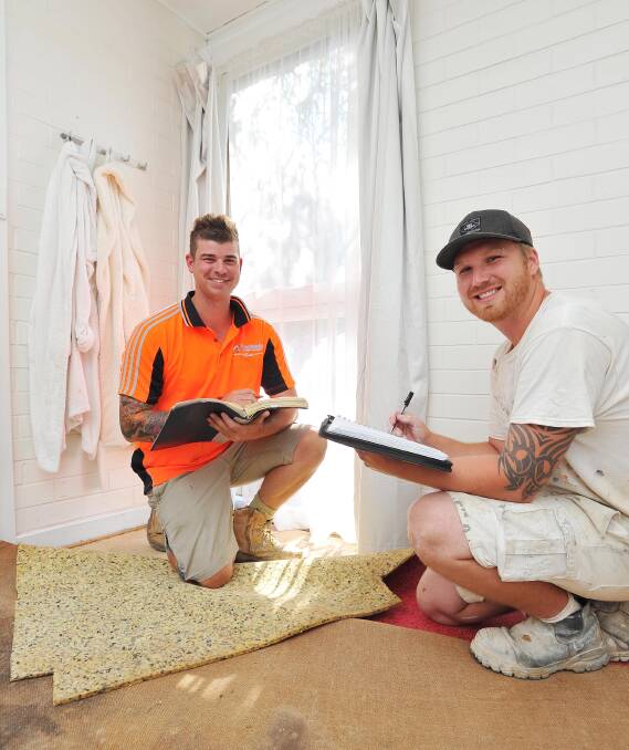 REPAIRS: Plasterer Lance Carr with painter Mitch Williams from Wagga Community Blitz surveying the damage of the flooded Kooringal home prior to starting repairs on the property. Picture: Kieren L.Tilly