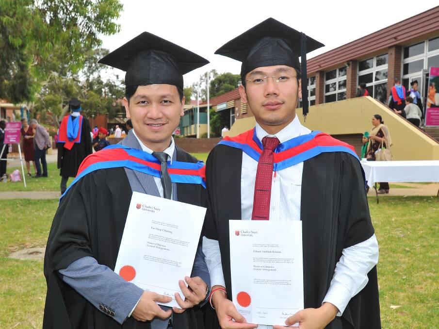 SATISFIED: Yun Seng Chhoung and Chhuon Sambath Ratanak were thrilled to finish their studies at Charles Sturt University. Photos: Kieren L.Tilly.