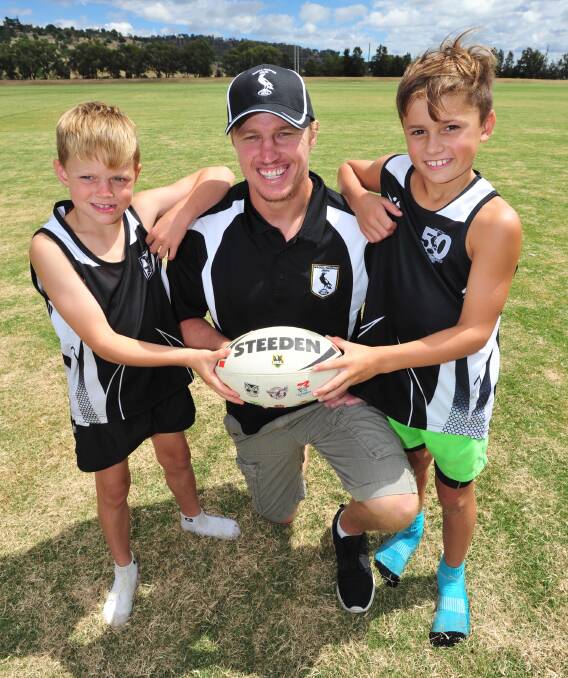 TOUCH OF CLASS: Wagga Magpies juniors Ben Hall, 9, and Gus Purcell, 9, enjoy the chance to learn tips of the trade from ex-NRL star Brett Finch at Parramore Park on Sunday. Picture: Kieren L Tilly