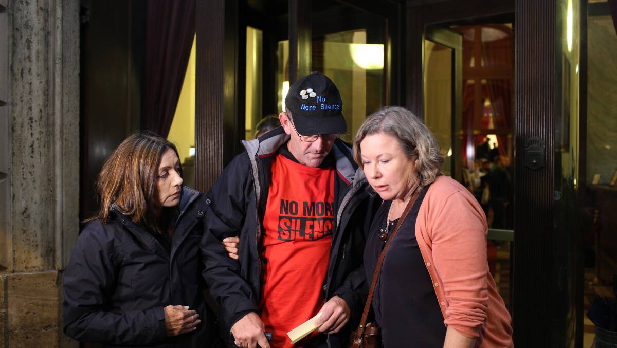 Paul Levey is comforted by supporters outside the hearing in Rome
